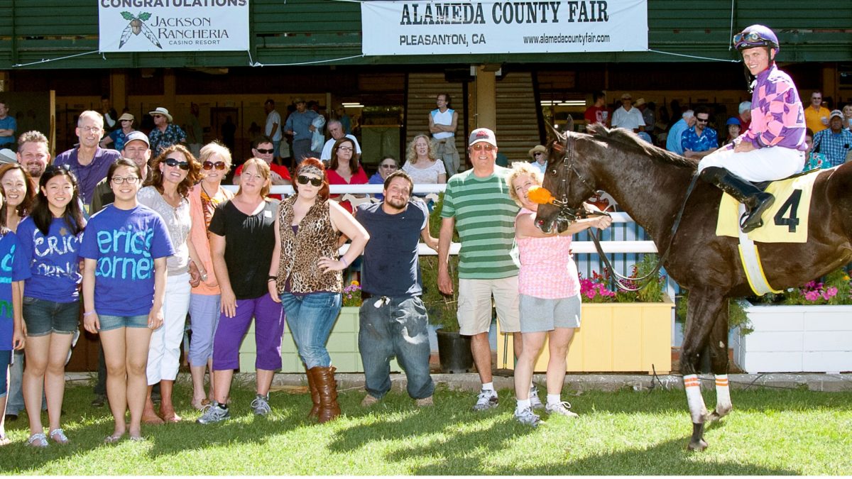 Group of people with winning horse