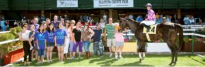 Group of people with winning horse