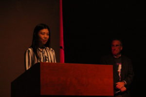 Woman presenting at a podium